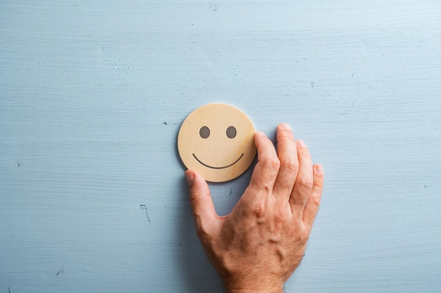 Smiling face cut into a wooden cut circle