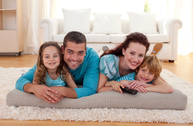 Smiling family on floor in living-room