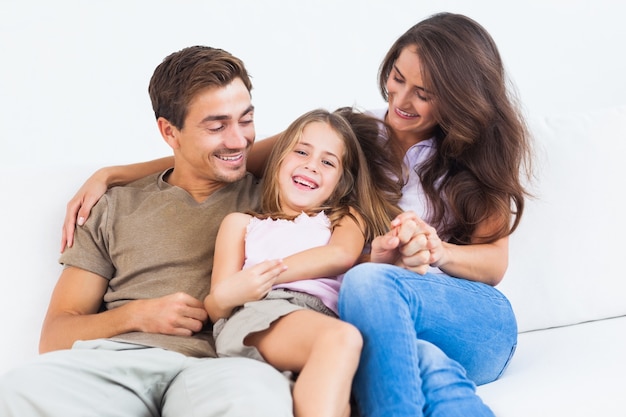 Smiling family playing together on a sofa