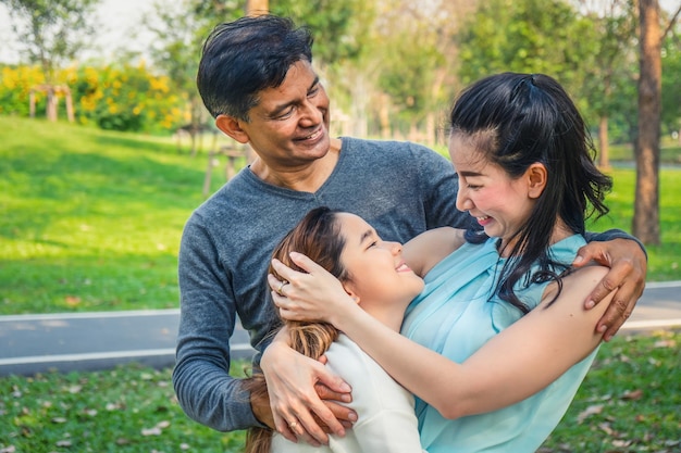 Smiling family standing on field