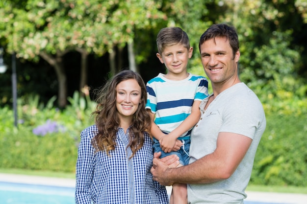 Smiling family standing together in the park