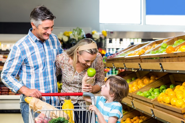 Smiling family behind their trolley