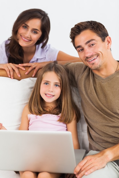 Smiling family using the laptop