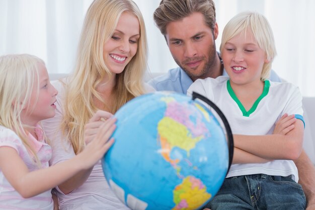 Smiling family with globe