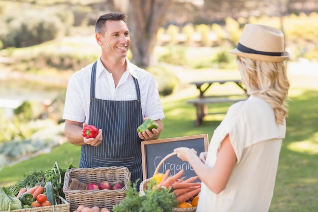 Smiling farmer discussing with a blonde customer