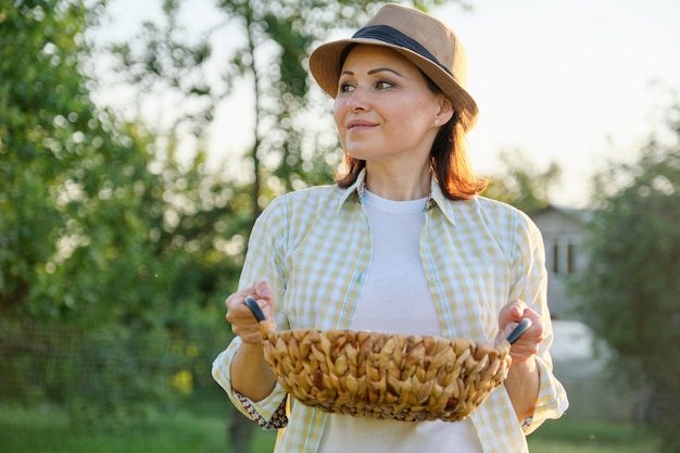 Smiling farmer woman walking with basket