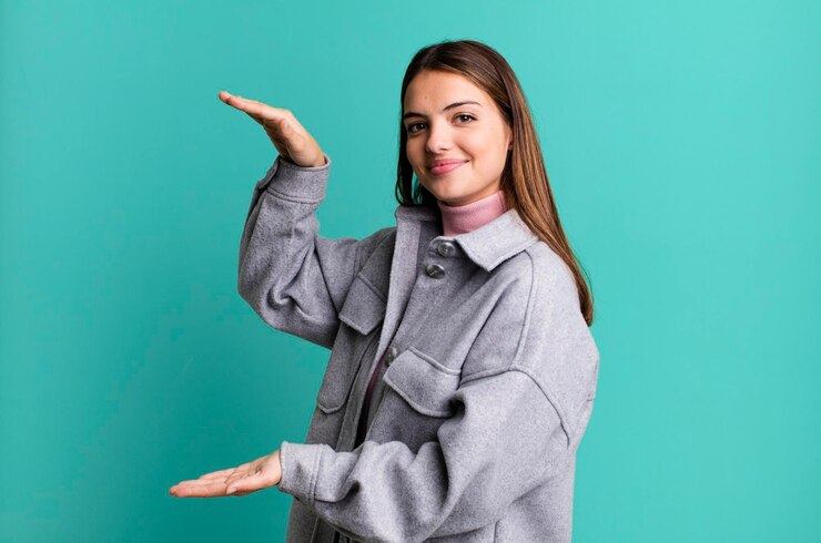 Photo smiling feeling happy positive and satisfied holding or showing object or concept on copy space