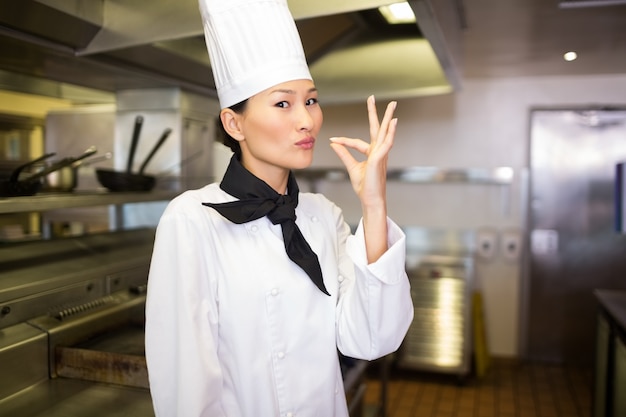 Smiling female cook in the kitchen