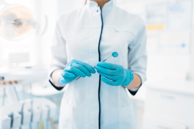 Smiling female dentist in dental clinic