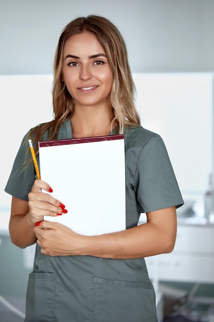 Smiling female doctor in hospital corridor Patients consultation