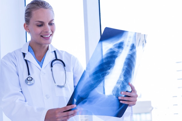 Smiling female doctor looking at Xray 