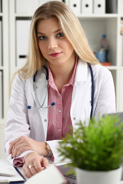 smiling female doctor sitting at workplace