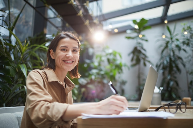 Smiling Female Entrepreneur in Outdoor Cafe