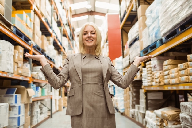 Smiling female manager showing with her hands