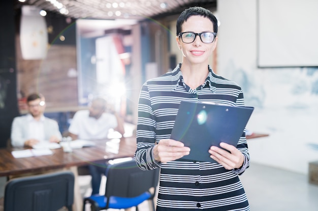 Smiling female manager with clipboard