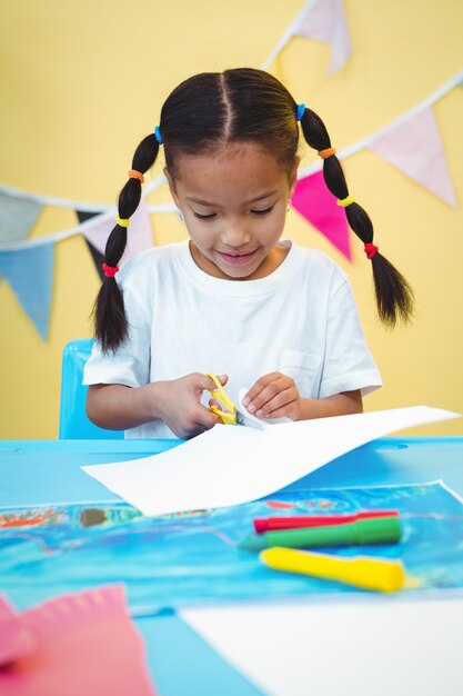 Smiling firl cutting some paper