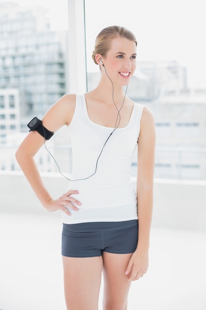 Smiling fit woman listening to music