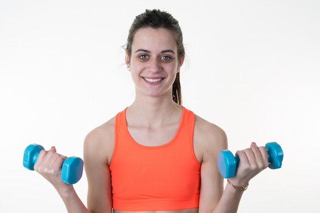 Smiling Fitness woman lifting weights exercising isolated