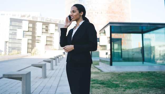 Smiling formal woman speaking on phone