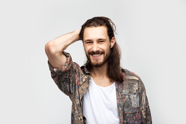 Smiling friendly fun guy, attractive and kind hippie. Hipster traveler stylish carefree man on a white studio background, people lifestyle