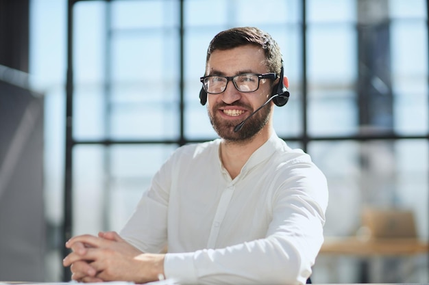 Smiling friendly handsome young male call centre operator