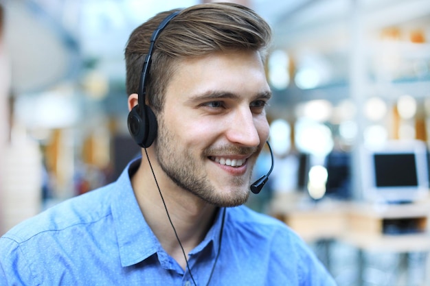 Smiling friendly handsome young male call centre operator