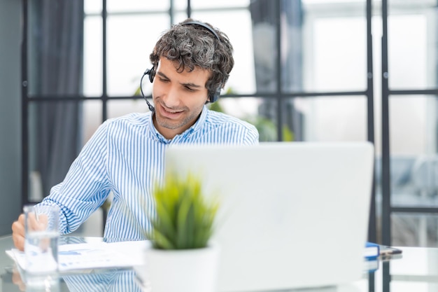 Smiling friendly handsome young male call centre operator