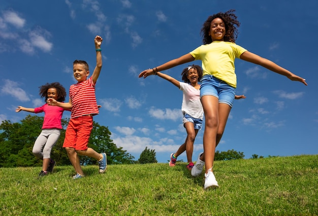 Photo smiling friends playing on grass against sky