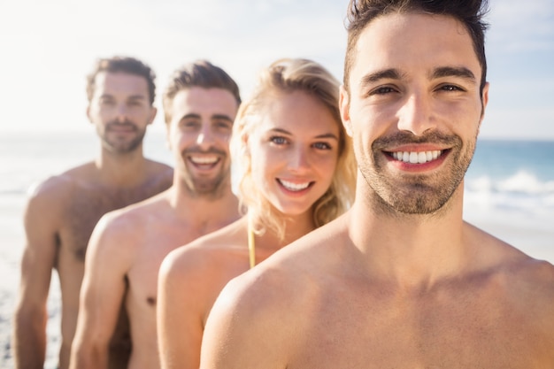 Smiling friends standing in line 