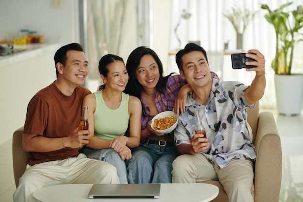 Smiling friends taking selfie