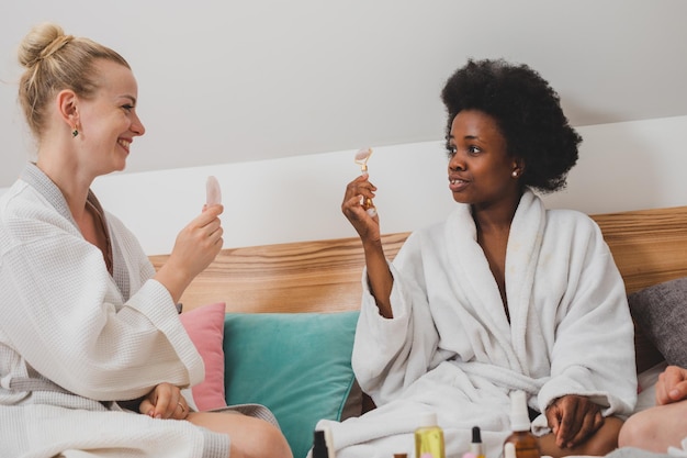 Photo smiling friends using digital tablet while sitting at home