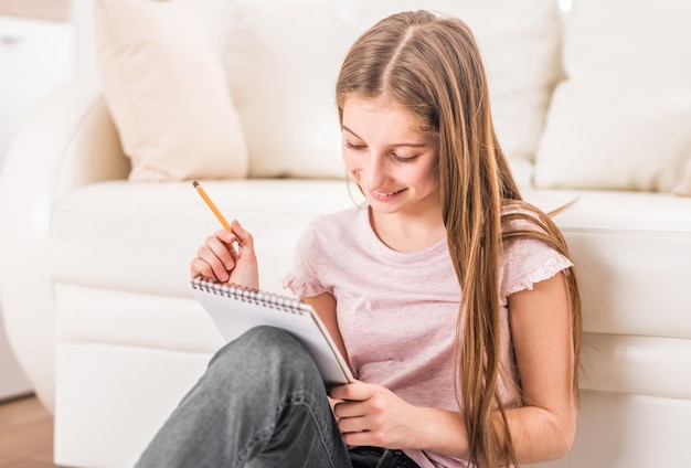 Smiling girl drawing pictures