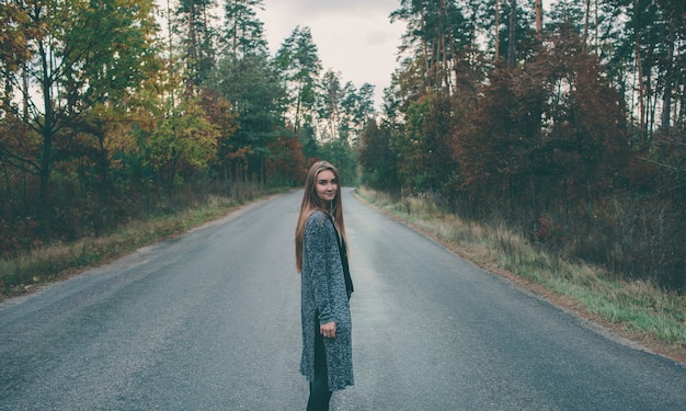 Smiling girl on forest road