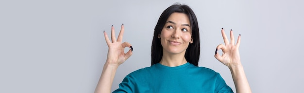 Smiling girl gesturing OK sign with her hand