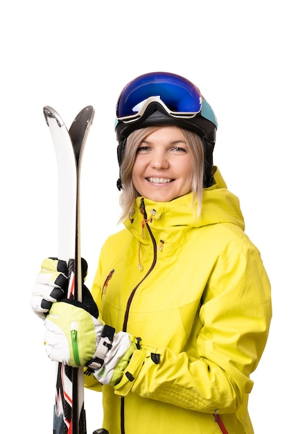 Smiling girl in helmet holding skis