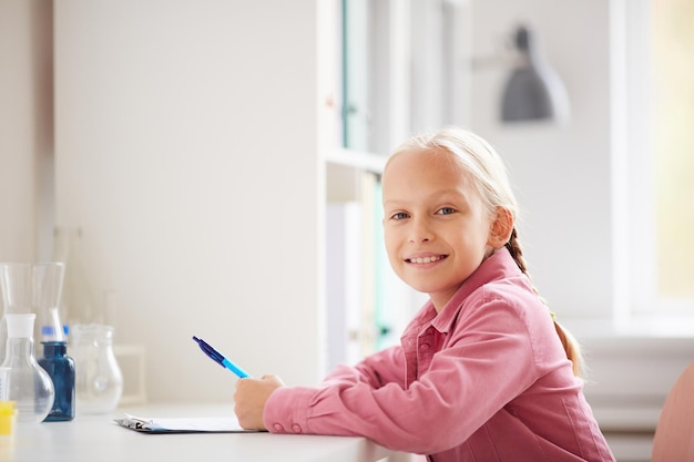 Smiling girl in laboratory