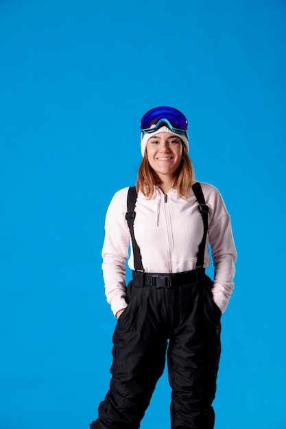 Smiling girl looking at the camera in snow gear