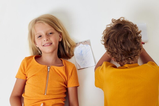 Photo smiling girl lying down by brother