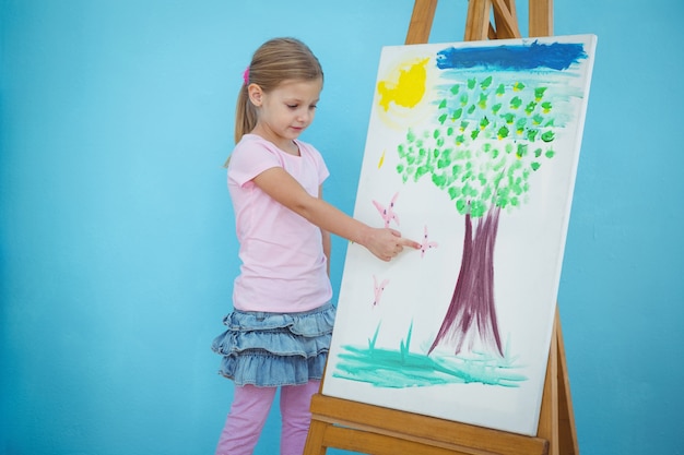 smiling girl pointing to her picture