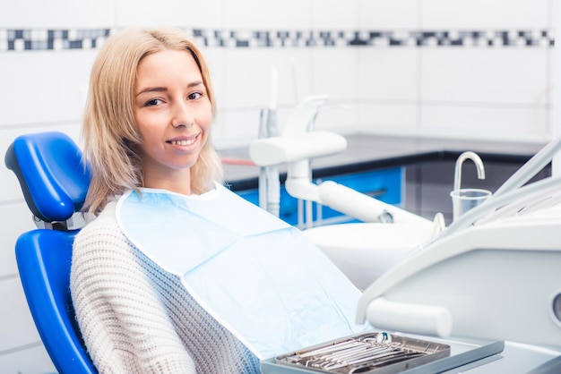 Smiling girl sitting in dentistry cabinet