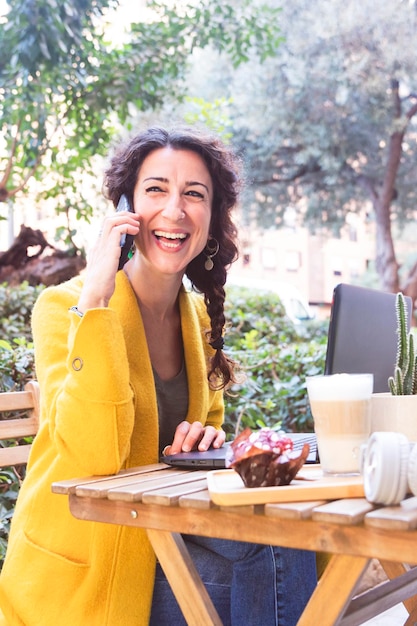 Smiling girl talking on the phone on an outdoor terrace