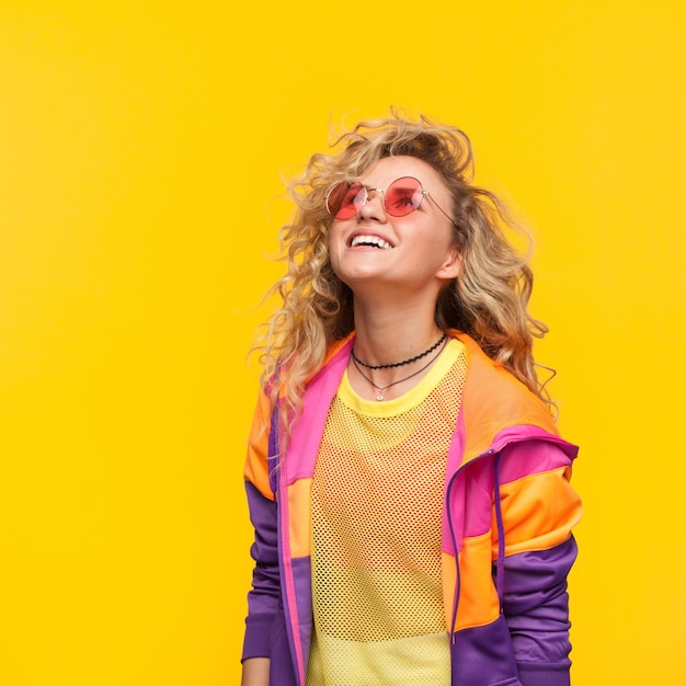 Smiling girl wearing sunglasses looking up