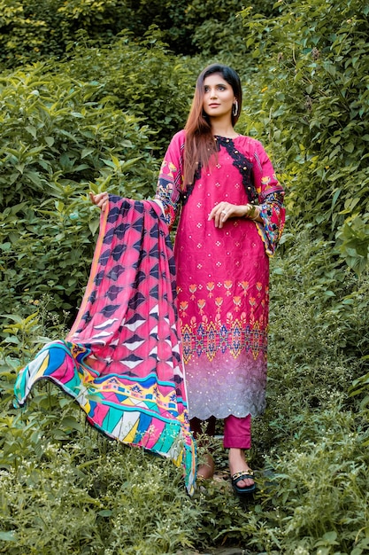 Smiling Girl Wearing Traditional Dress Jewelry and Makeup for Fashion Shoot in Green Mountains