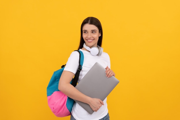 Smiling girl with backpack and headphones webinar for modern education