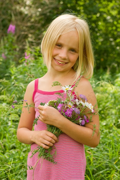 Smiling girl with flowers outdoor