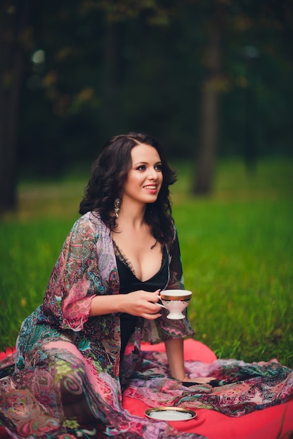 Smiling girl with mug in her hands. Girl drinking tea.