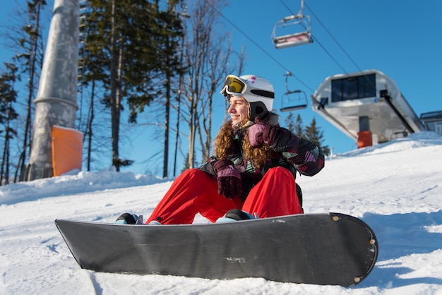 Smiling girl with snowboard