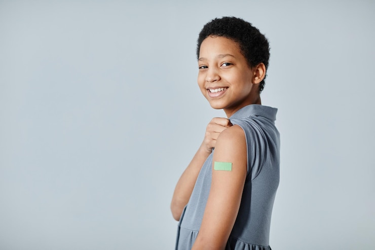 Smiling Girl with Vaccine Plaster