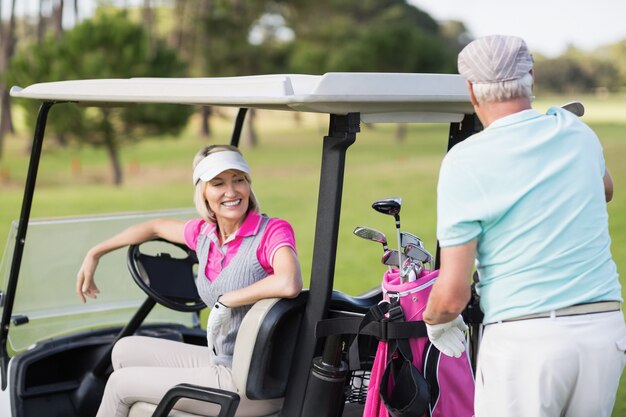 Smiling golfer couple