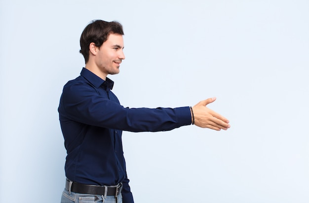 Foto sorridendo, salutandoti e offrendo una stretta di mano per concludere un affare di successo, concetto di cooperazione